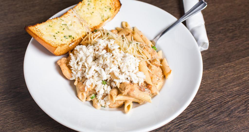 Seafood Lafourche Pasta · Sautéed gulf coast shrimp, crawfish tails, sun-dried tomatoes, spring peas, homemade alfredo sauce, penne pasta, topped with lump crab meat. Served with toasted garlic bread.
