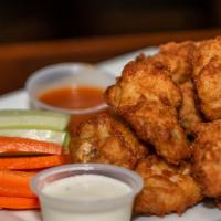 Wings (Bone-In/10) · Tossed in choice of sauce. Served with carrots and celery and choice of bleu cheese or ranch.