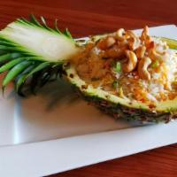 Pineapple Fried Rice · Chicken and shrimp stir-fried with pineapples, cashews, and egg.