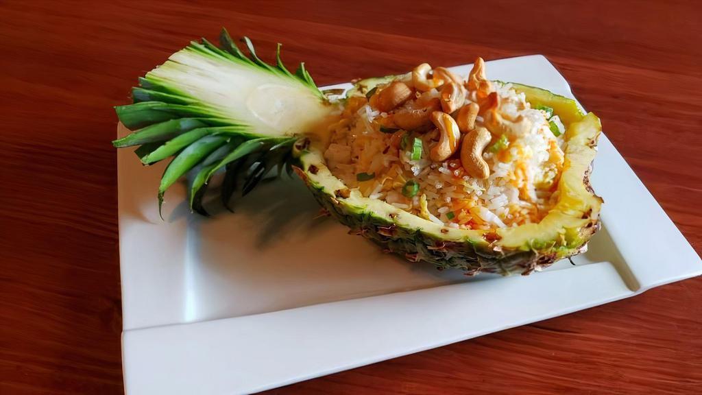 Pineapple Fried Rice · Chicken and shrimp stir-fried with pineapples, cashews, and egg.