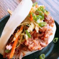 Kalua Pork Bun · Slow cooked smoky pulled pork, cucumber, romaine lettuce, pickled, carrots, scallions, barbe...