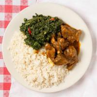Curry Goat · Caribbean styled curry goat served with rice and fried plaintain.
