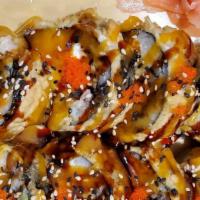 Golden Dragon Roll · Whole roll tempura with salmon, tuna, avocado and cream cheese, chef special sauce.