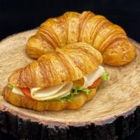 Turkey & Cheese Croissant Sandwich · All-natural oven-roasted turkey breast, Swiss cheese, lettuce, tomato, and mayonnaise. Serve...