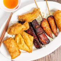 Pu Pu Platter For 2 · 2 egg rolls, 2 crab meat wonton, 2 BBQ ribs, 2 chicken on a stick and 2 chicken wings.