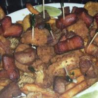 Colombian Picada · Half tray with a deep-fried chicken dice, fried pork, cassava fries, plantain, sliced sausag...