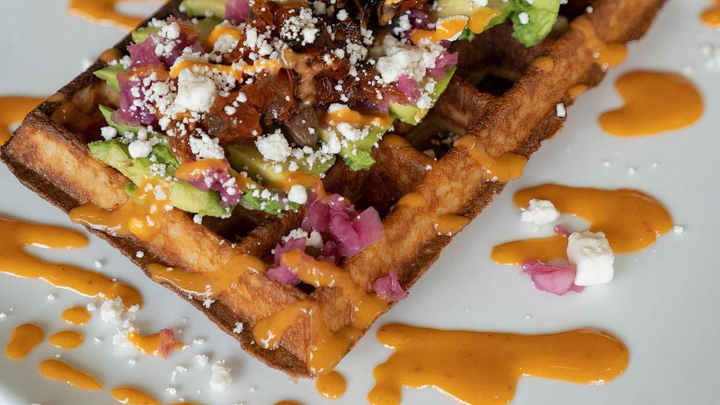 Avocado Toast Waffle · Sliced avocado, oven-roasted tomatoes, goat cheese, red onions capers, and chipotle glaze.