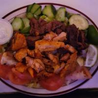 Botana Grande · Grilled Chicken, beef and shrimp, chicken wings, pupusas over mixed salad, blue cheese or ra...