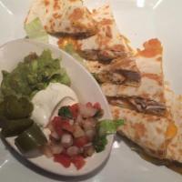 Quesadillas · Two fresh flour tortilla stuffed with Mexican cheese. Served with pico de gallo, guacamole, ...