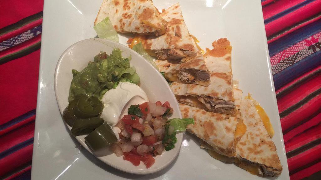 Quesadillas · Two fresh flour tortilla stuffed with Mexican cheese. Served with pico de gallo, guacamole, and sour cream.