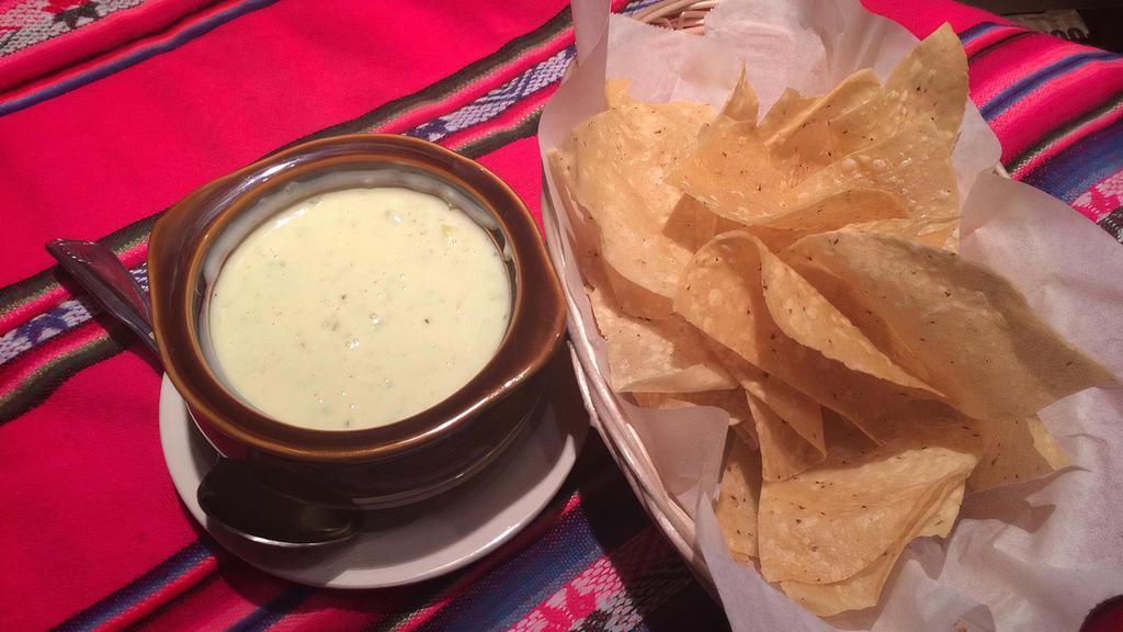 Chile Con Queso & Chips · White or Yellow Cheese dip with or with out Ground Beef
