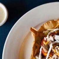 Taco Salad · Crispy tortilla shell filled with romaine lettuce, tomatoes, red onions and beans. Served wi...