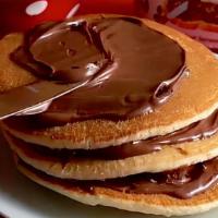 Nutella Pancakes · Two large Nutella buttermilk pancakes with Nutella, butter, and syrup.