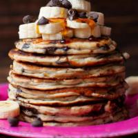 Banana Chocolate Chip Pancakes · Two large buttemik pancakes with chocolate chips, bananas, butter and syrup.