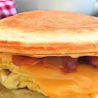 Bacon, Egg & Cheddar Pancake Sandwich · Bacon, egg and cheddar cheese sandwiched between two pancakes. Dusted with powdered sugar an...
