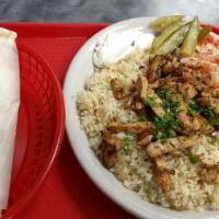 Shawarma Plate · Grilled Chicken or Beef served on a bed of rice with sliced onion, tomato, garlic sauce, and...