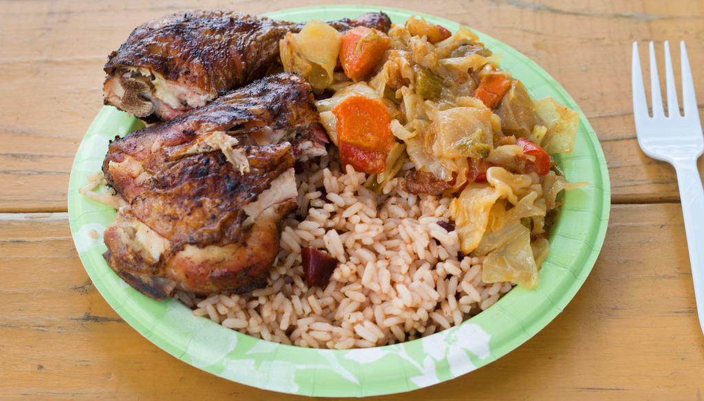 Jerk Chicken Plate · Leg quarters marinated in my special blend of spices & jerk seasoning, slow cooked on a wood fire, served with Rice-n-Beans and Veggies.