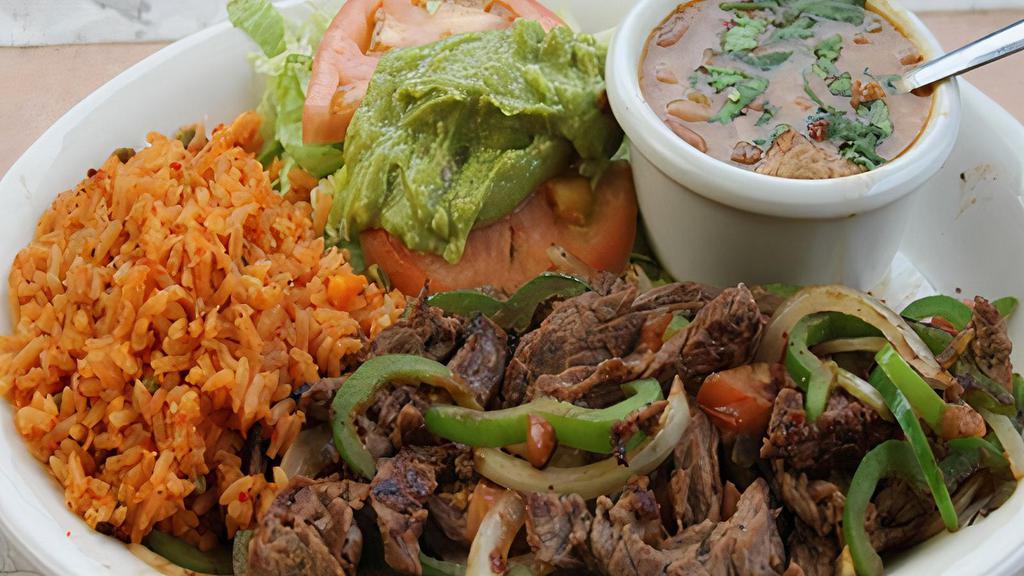 #15) Fajita A La Plancha Lunch Plate · Beef fajitas with sautéed bell peppers and  onions, charro style beans, rice, guacamole, and salad.