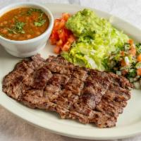 #1) Carne Asada Plate · A fajita skirt steak, thinly cut, served with charro beans, pico de gallo, guacamole, and tw...