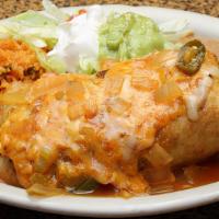 Chimichanga Plate · Crispy burrito topped with salsa ranchera and  served with rice, beans, salad, guacamole, an...