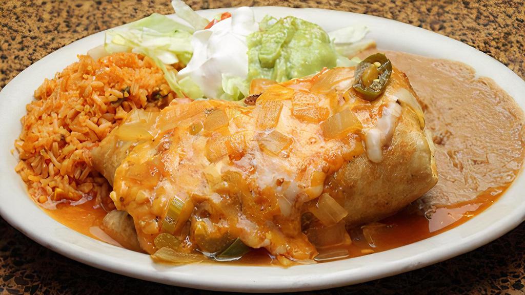 Chimichanga Plate · Crispy burrito topped with salsa ranchera and  served with rice, beans, salad, guacamole, and sour cream.