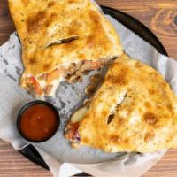 Greek Calzone
 · Slices of Lamb Beef Gyro, Onions, Tomatoes, Olives, Feta Cheese, and Mozzarella