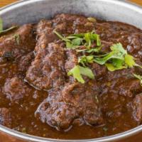 Lamb Keema · Ground meat slow cooked with peas and onion.