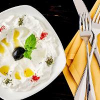 Labneh With Zaatar Chips · Strained yogurt, olive oil, dried mint, toasted zaatar chips.