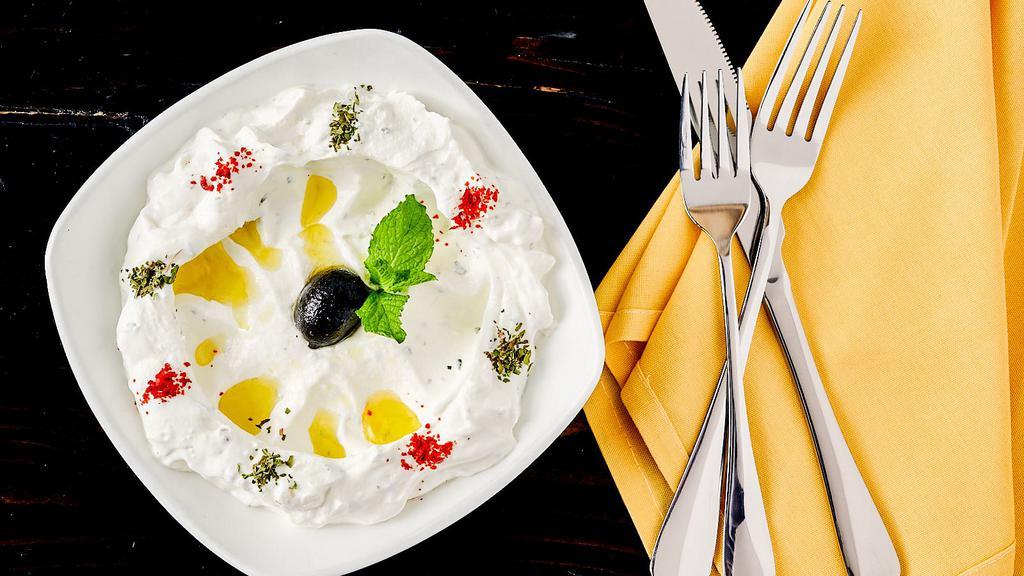 Labneh With Zaatar Chips · Strained yogurt, olive oil, dried mint, toasted zaatar chips.