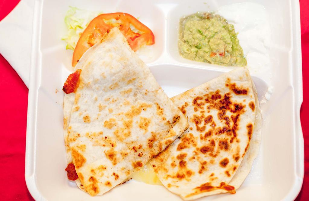 Single Quesadilla · Flour tortilla, Monterey Jack Cheese, with guacamole & sour cream *Choice Of Any Meat +3.00