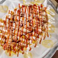 Salchipapa · Loaded french fries topped with sliced fried hot dog, mayo, mustard and ketchup. Please choo...