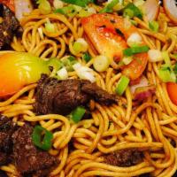 Tallarín Saltado · Pan stir-fry Peruvian-style beef lo-mein, cooked with tomatoes, onions, soy sauce and our Pe...