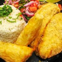 Fried Fish · Delicious fried fish - tilapia with a side of white rice, onion salad, and garnished with tw...