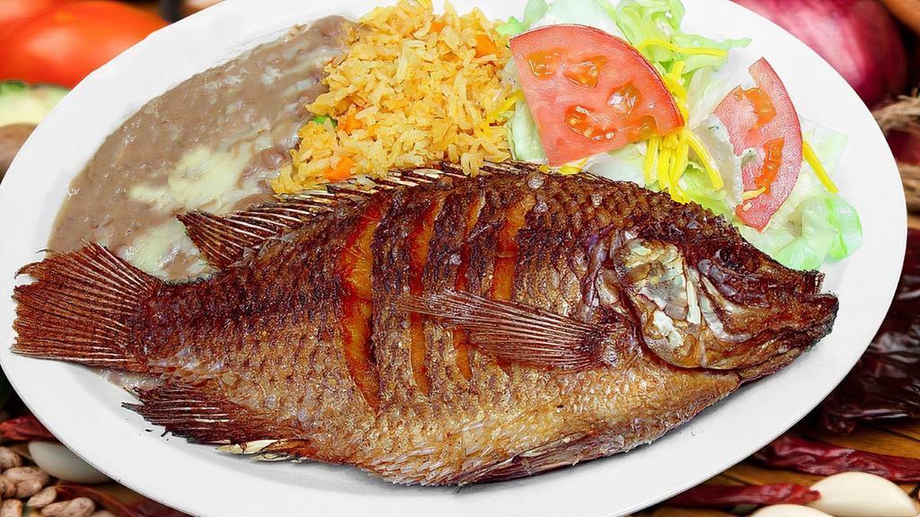 Mojarra Frita · A lightly seasoned, whole fried tilapia fish served with salvadorean rice, fried beans, small salad and two handmade corn tortilla.