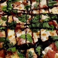 Caprese Pizza · Mozzarella, roasted tomatoes, garlic, basil, balsamic glaze