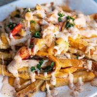 Lobster Fries · Fresh poached lobster meat sauteed with cajun cheese sauce over a bed of cajun hand cut fries