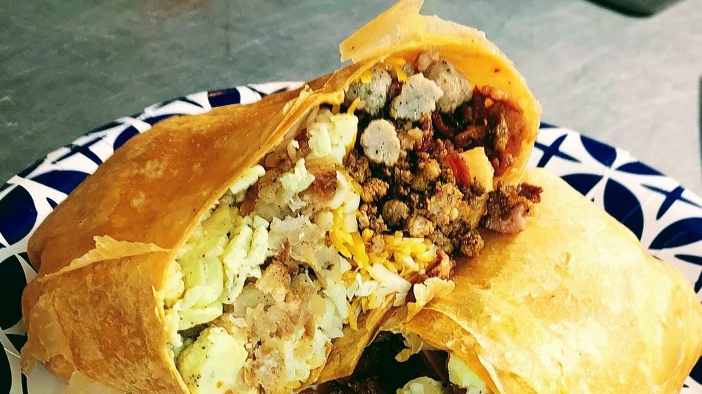 Time To Eat Signature - The Montana Mega · This one-pound burrito is loaded with all the meat choices, both cheddar and pepper jack cheese and homemade **bomb sauce wrapped in a huge tomato/chili tortilla.