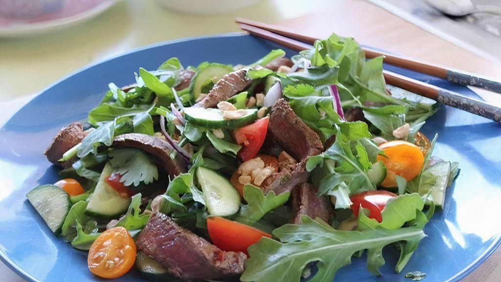 Beef Salad · Red Onions, Cilantro, Green Onions, Tomato, Carrots, Lemongrass, Lime, Cucumbers, Mixed Green served house dressing.