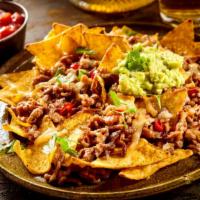 Country Boy Nachos · A massive mound of homemade flour tortilla chips topped with pulled pork, smoked brisket, an...