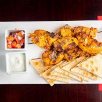 Chicken Tikka Skewers · Marinated spiced chicken, grilled & served with a mint chutney & warm pita triangles.