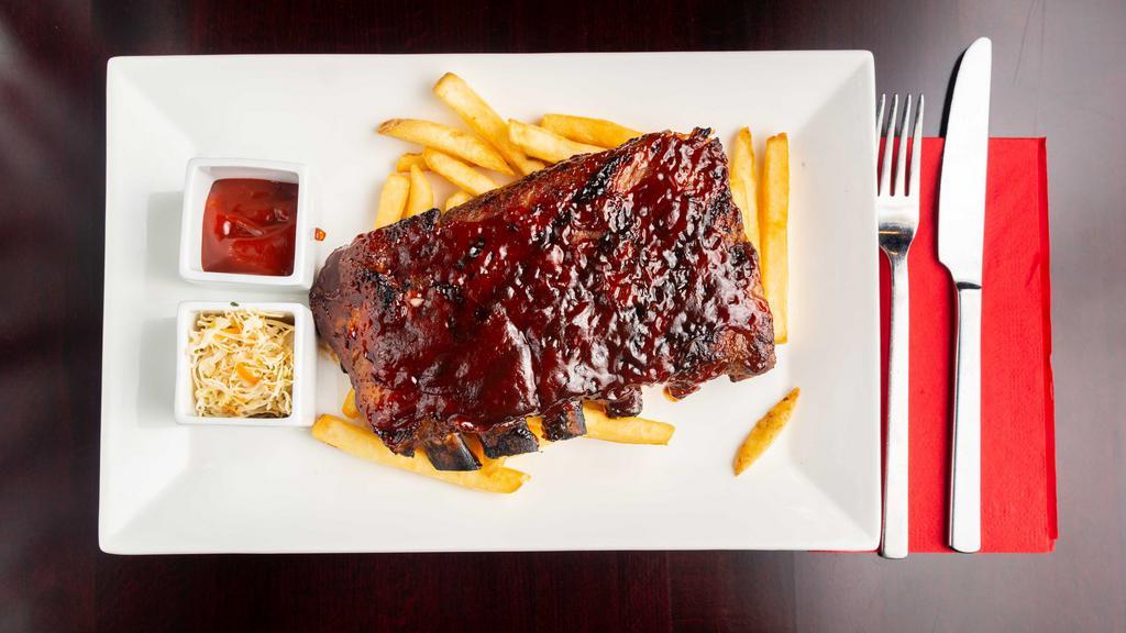 Smoked Baby Back Ribs · Slow roasted St. Louis ribs slathered with BBQ, fire grilled with fries & slaw.