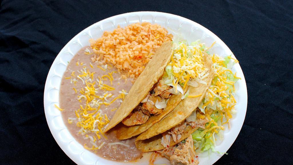 #9 2 Chicken Tacos · Two chicken tacos topped with cheese and lettuce. Served with rice and beans.