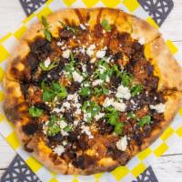 The Oaxaca · House made mole sauce with shredded chicken over our cheese blend topped with feesh cilantro...