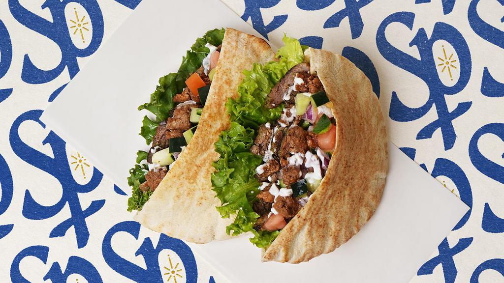 Beef & Lamb Gyro Pita · Mixed beef & lamb gyro with lettuce, tomatoes, cucumber, onions, and your choice of sauce wrapped in a pita