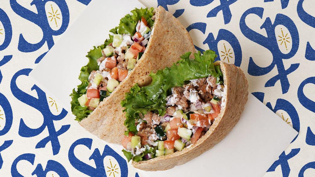 Chicken Gyro Pita · Chicken gyro with lettuce, tomatoes, cucumber, onions, and your choice of sauce wrapped in a pita