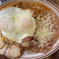 Homemade Chilaquiles · Fried corn tortillas on red sauce topped with sour cream, onions, Monterey jack cheese, two ...