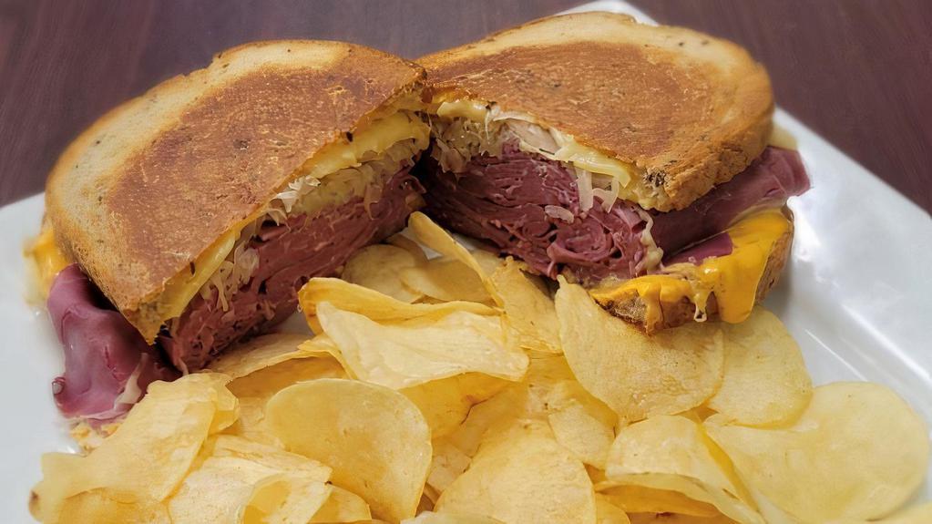 Classic Reuben Sandwich Combo · 7 oz Corned Beef, Sauerkraut, Russian Dressing & Melted Swiss Cheese on grilled Rye Bread served with chips & drink.