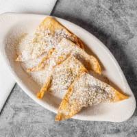 Sambosa · Pan-fried turnovers stuffed with minced beef and lentils, topped off with powdered sugar and...