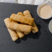 Tequeños · Deep fried mozarella cheese sticks wrapped in pastry like dough ( 6 per serving)