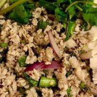 Larb Gai · Ground chicken in spicy lime juice garnished with red and green onion, cilantro. Served on f...